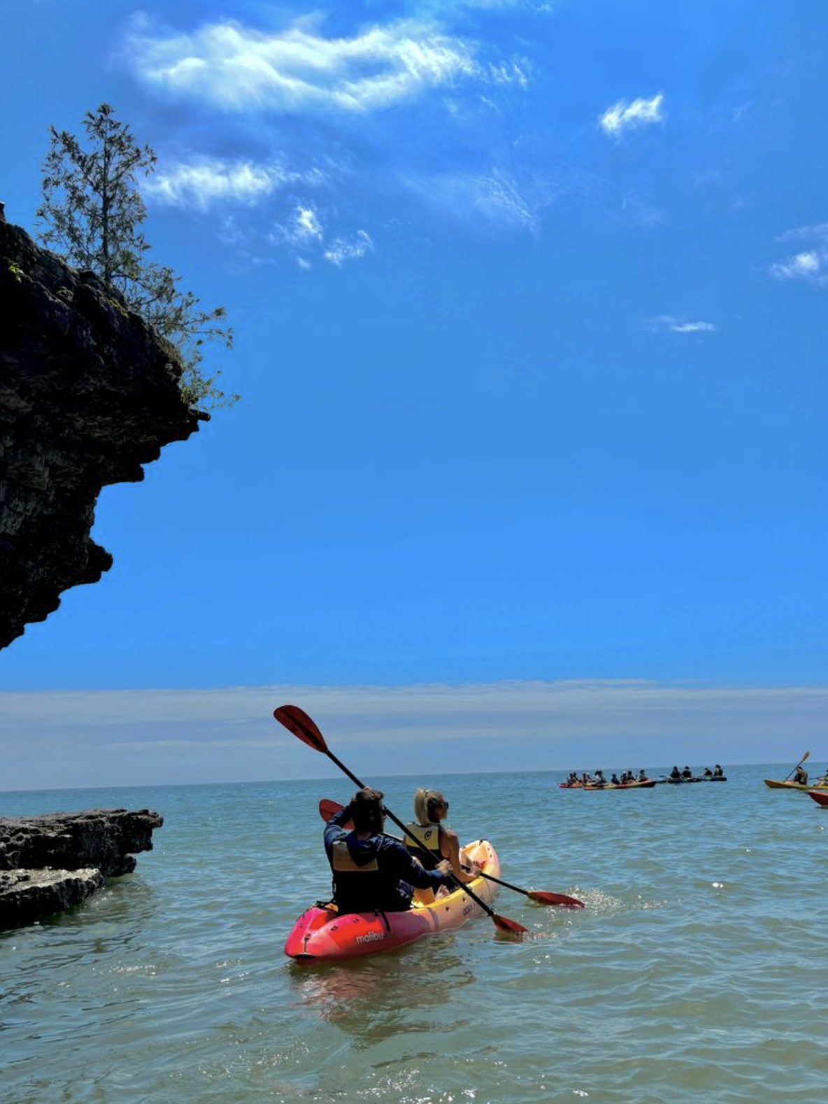 couple kayaking on minimoon around cliffs of Door County Wisconsin