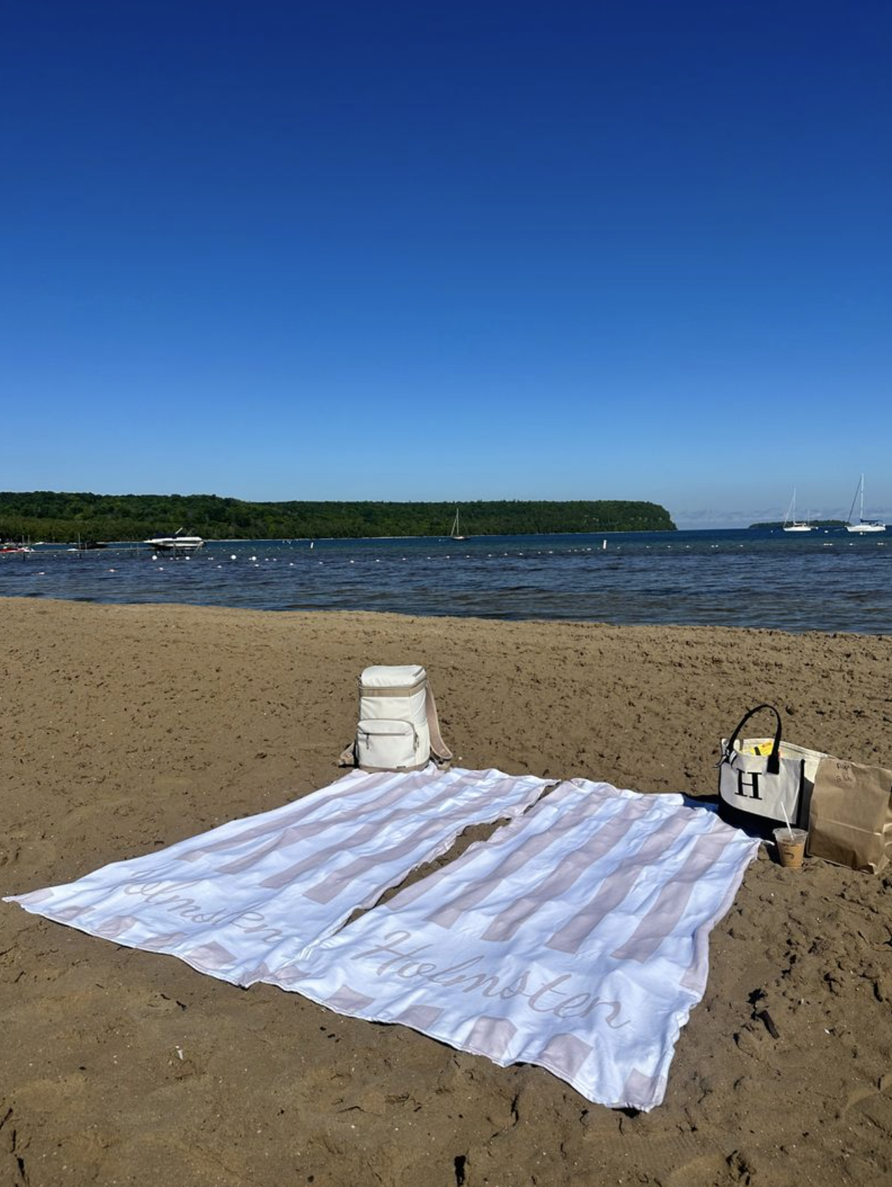 striped beach blanket for newly weds on sandy beach