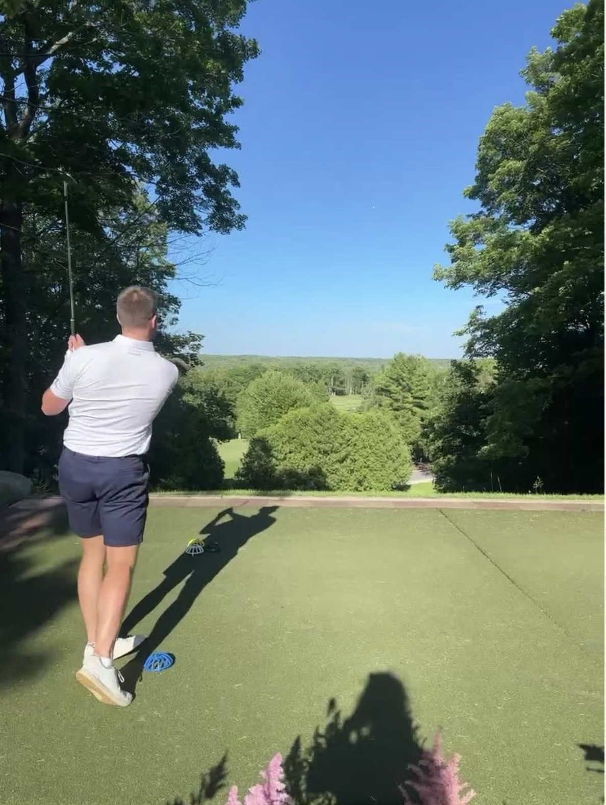 man teeing off at beautiful golf course
