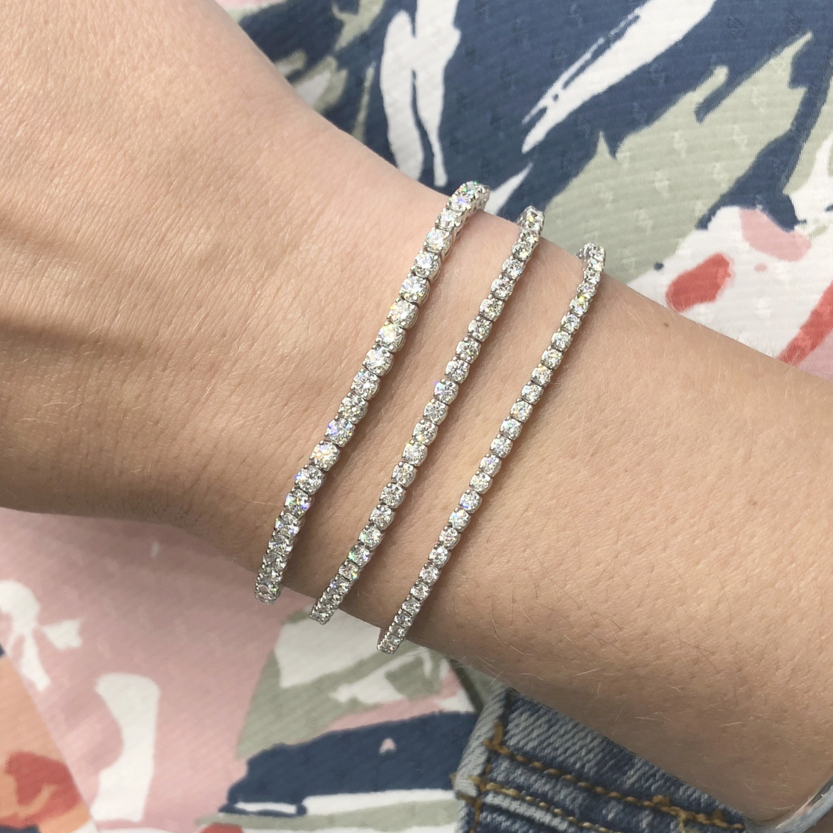 woman wearing layered diamond tennis bracelets