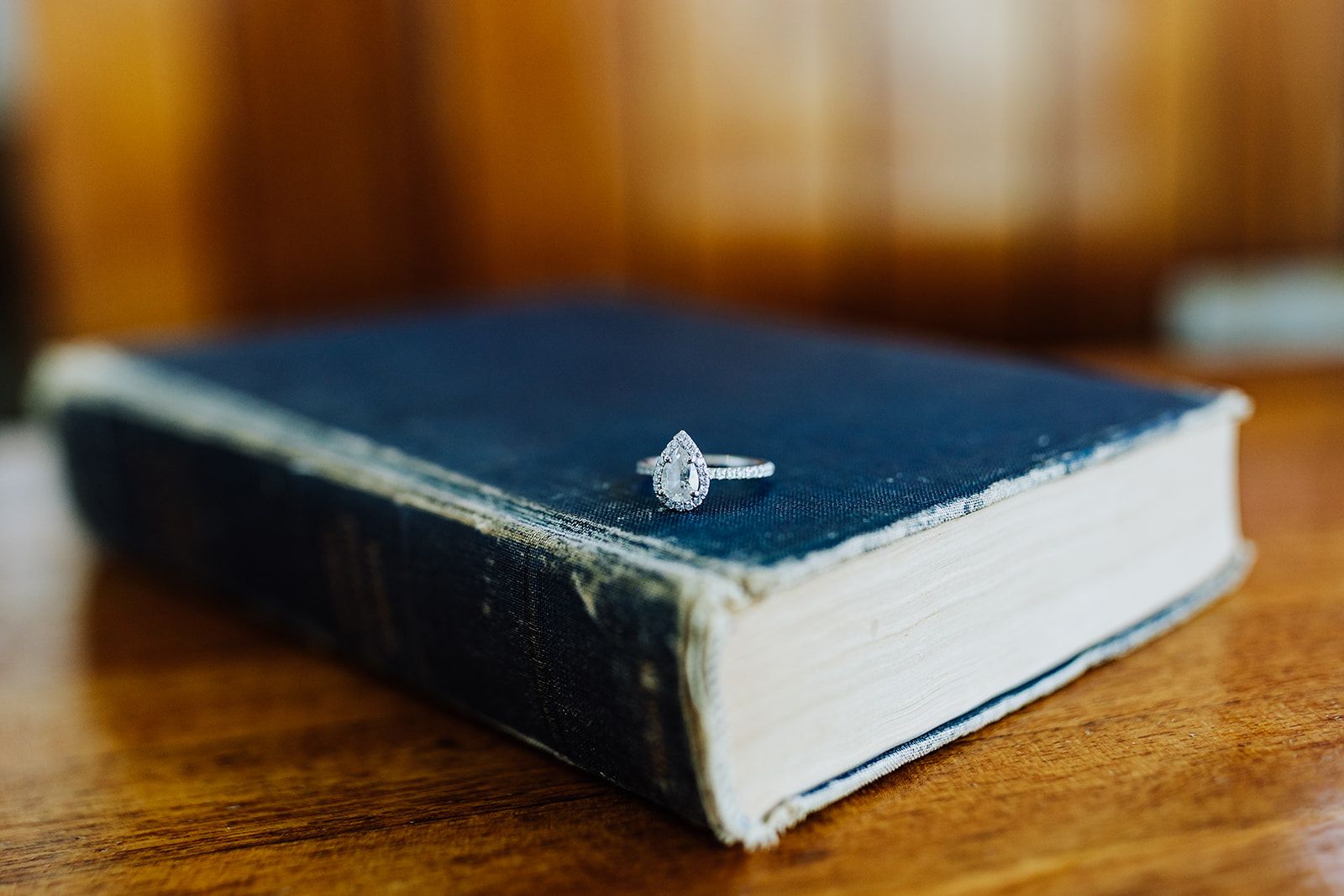 engagement ring on antique hardcover book