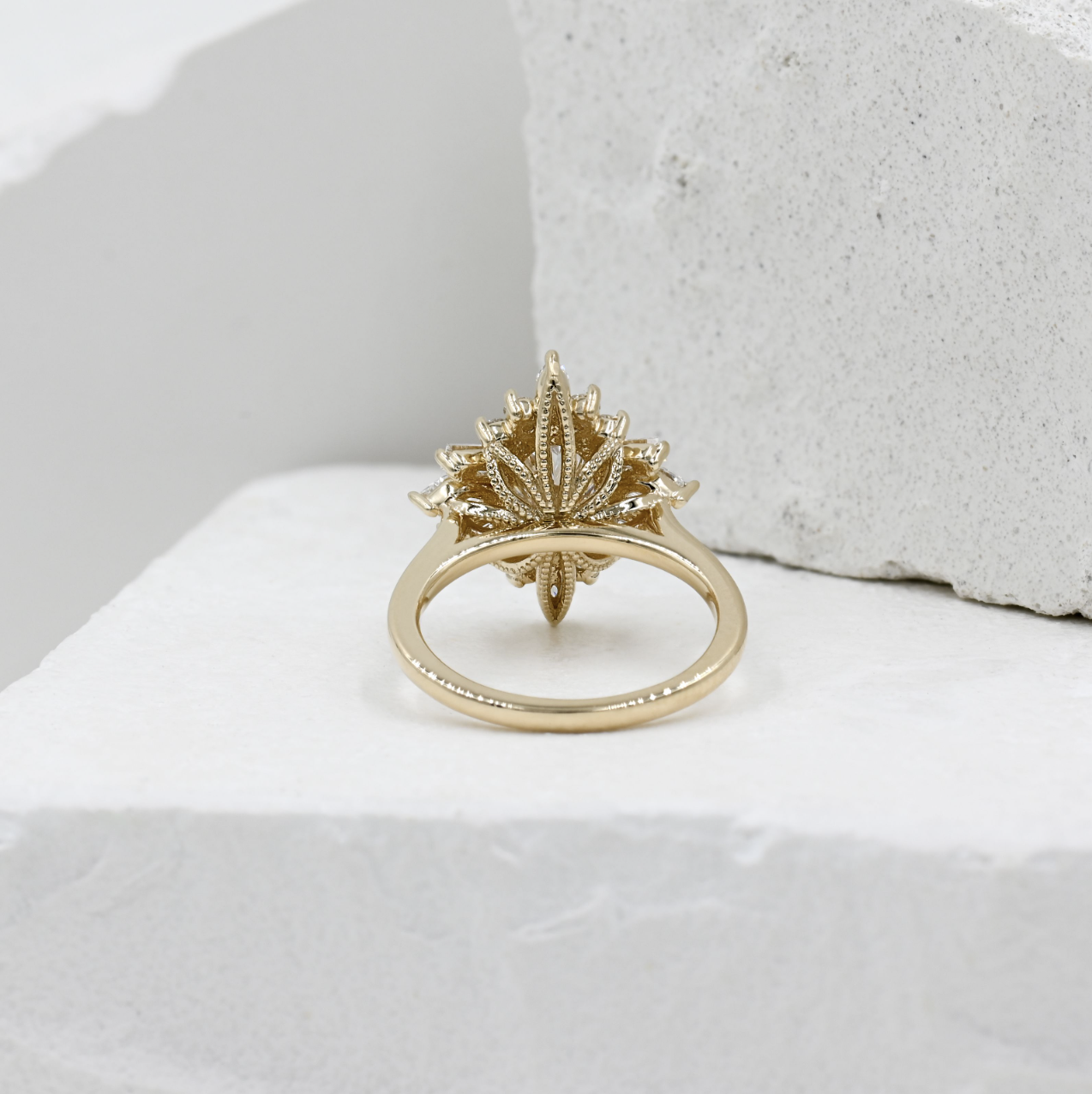 yellow gold ballerina style halo oval engagement ring with filagree details