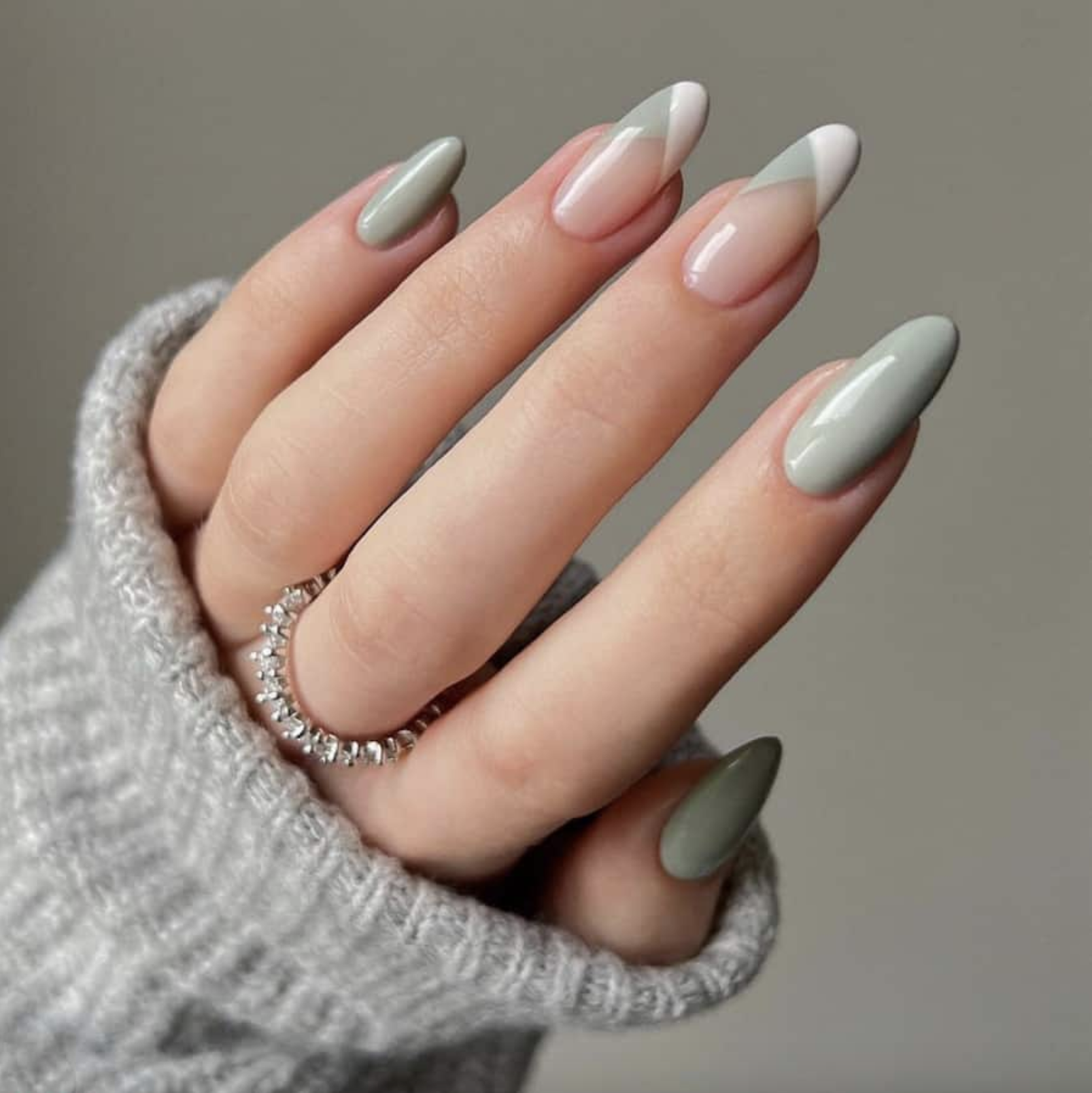 sage green earth-tone manicure with diamond eternity band