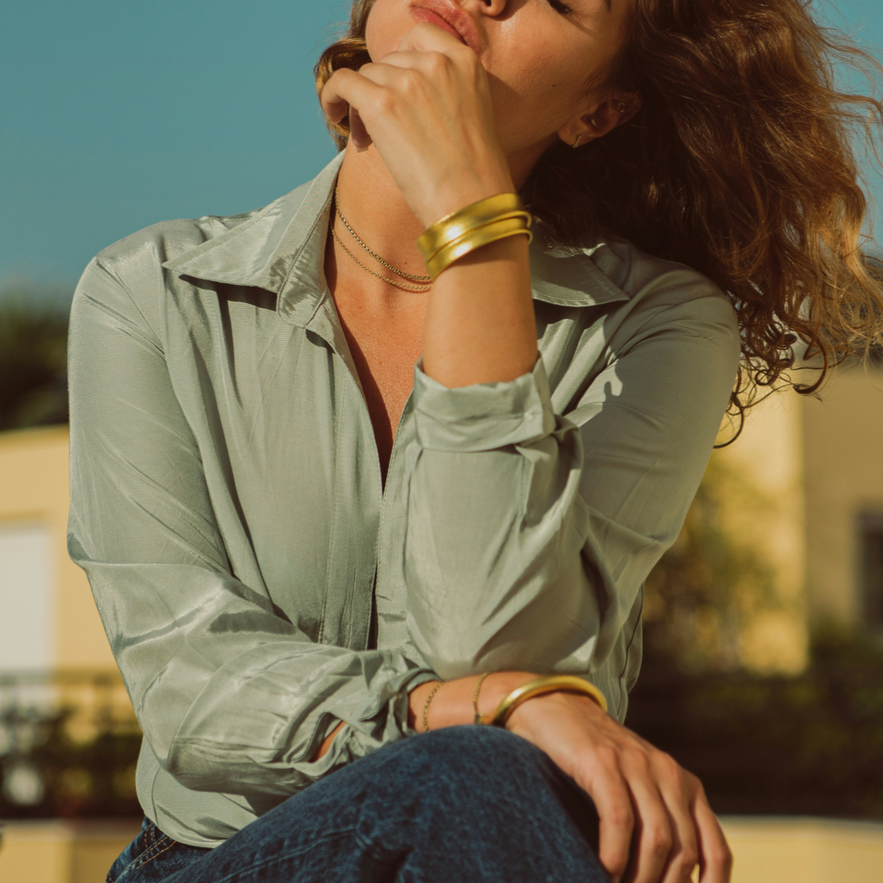 woman in summer wearing layered bangle bracelets