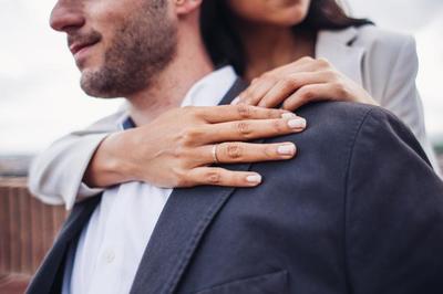 couple, happy couple, business couple, woman's hands, wedding ring, engagement ring, mens suit coat, women's suitcoat, pale pink nail polish, men's denim jacket