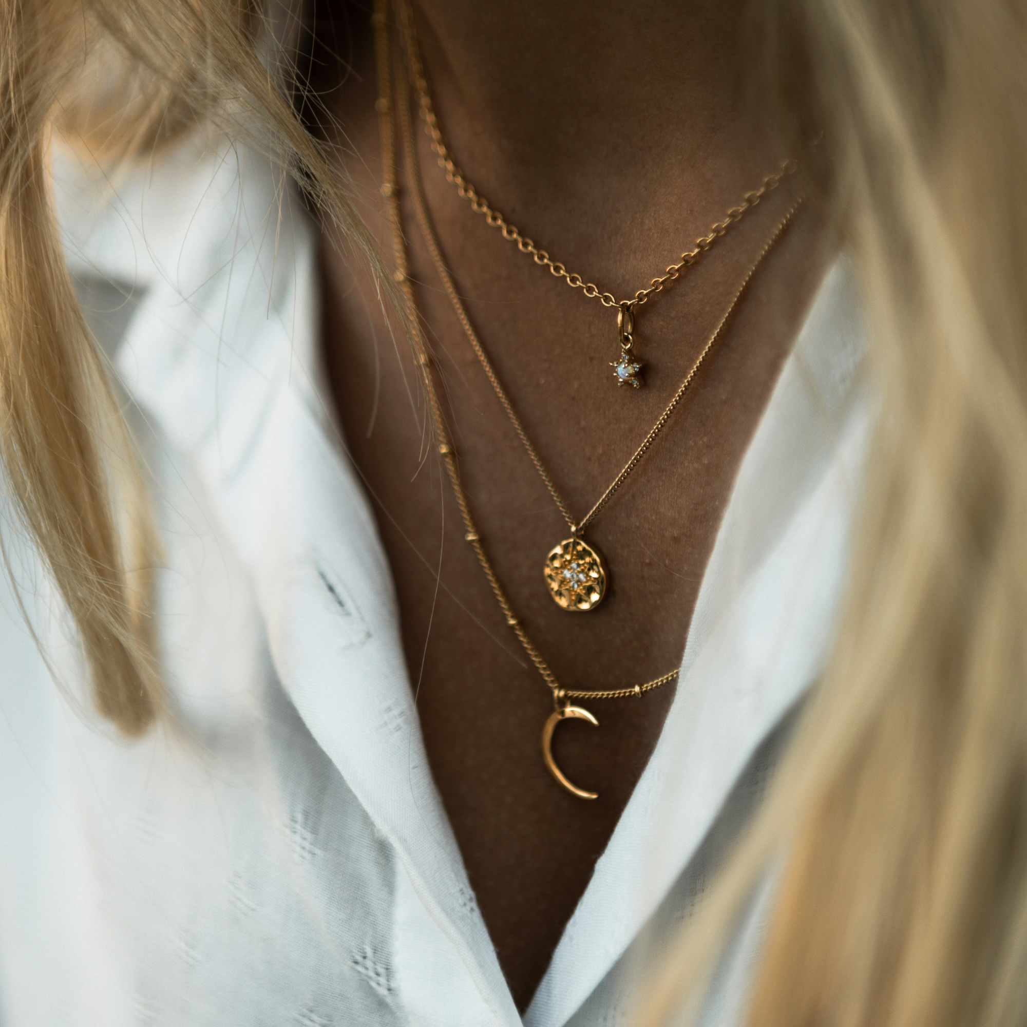 blonde woman wearing layered necklaces