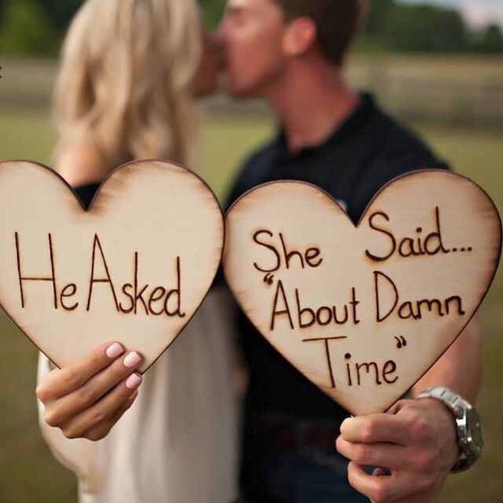 engagement photo idea, wooden hearts, wooden placards, happy couple, kissing couple, watch, wristwatch, engagement photo ideas