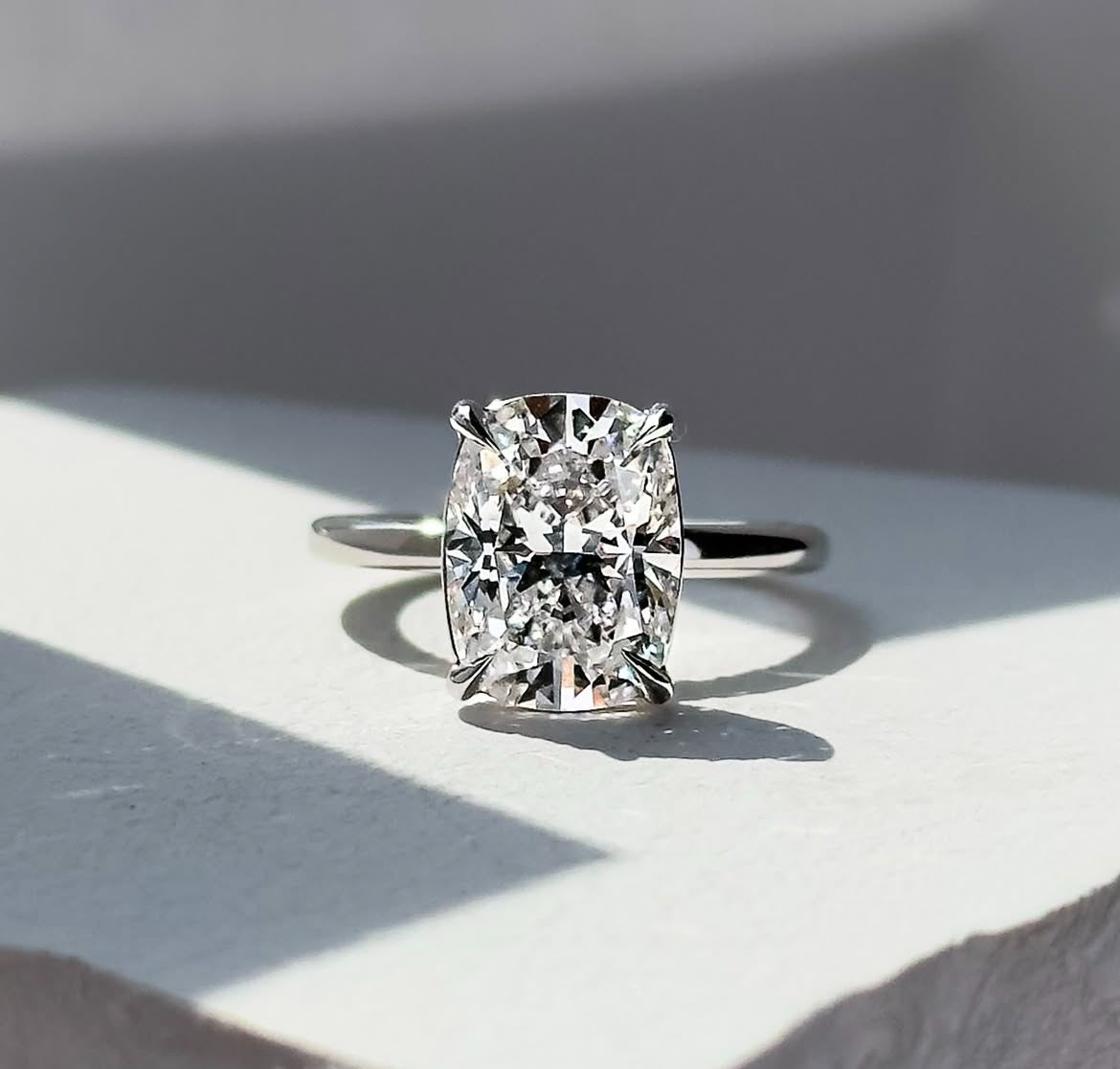 bezel mounted elongated cushion cut engagement ring