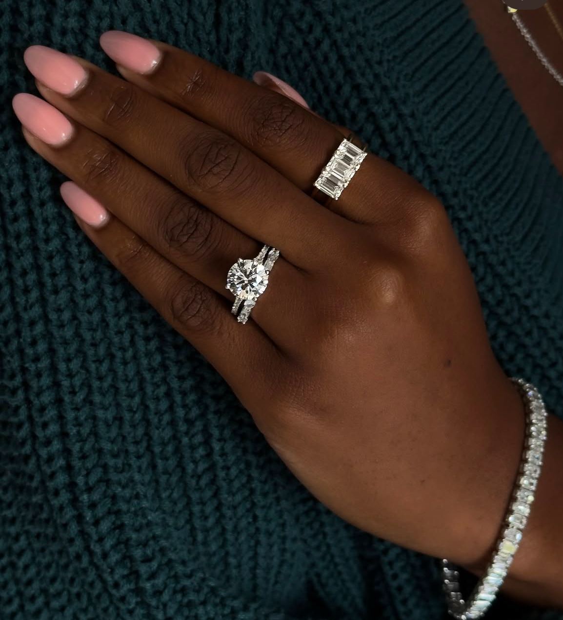 Black woman's hand with wedding stack and diamond eternity band