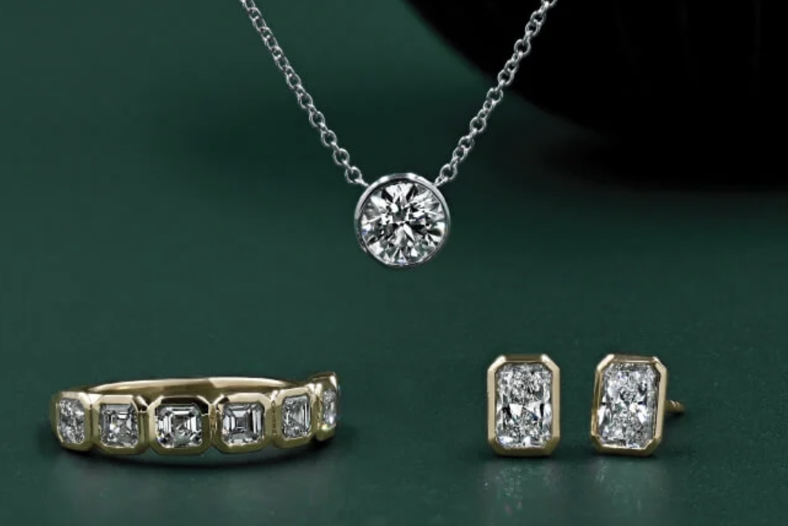 bezel mounted diamond ring, solitaire pendant, and diamond studs