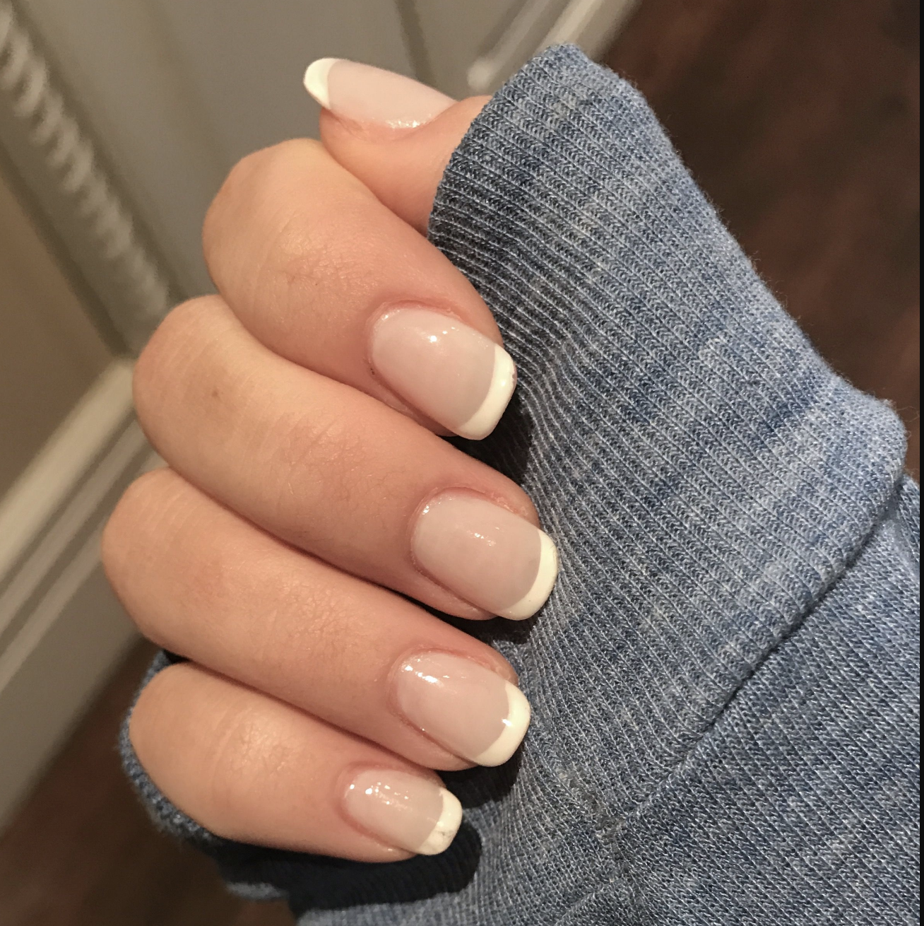 french manicure with grey long sleeve top