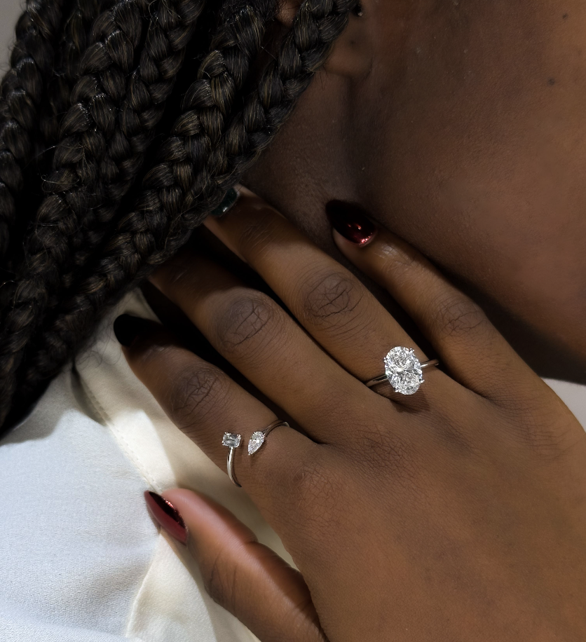 beautiful Black woman in oval diamond engagement ring and toi et moi ring