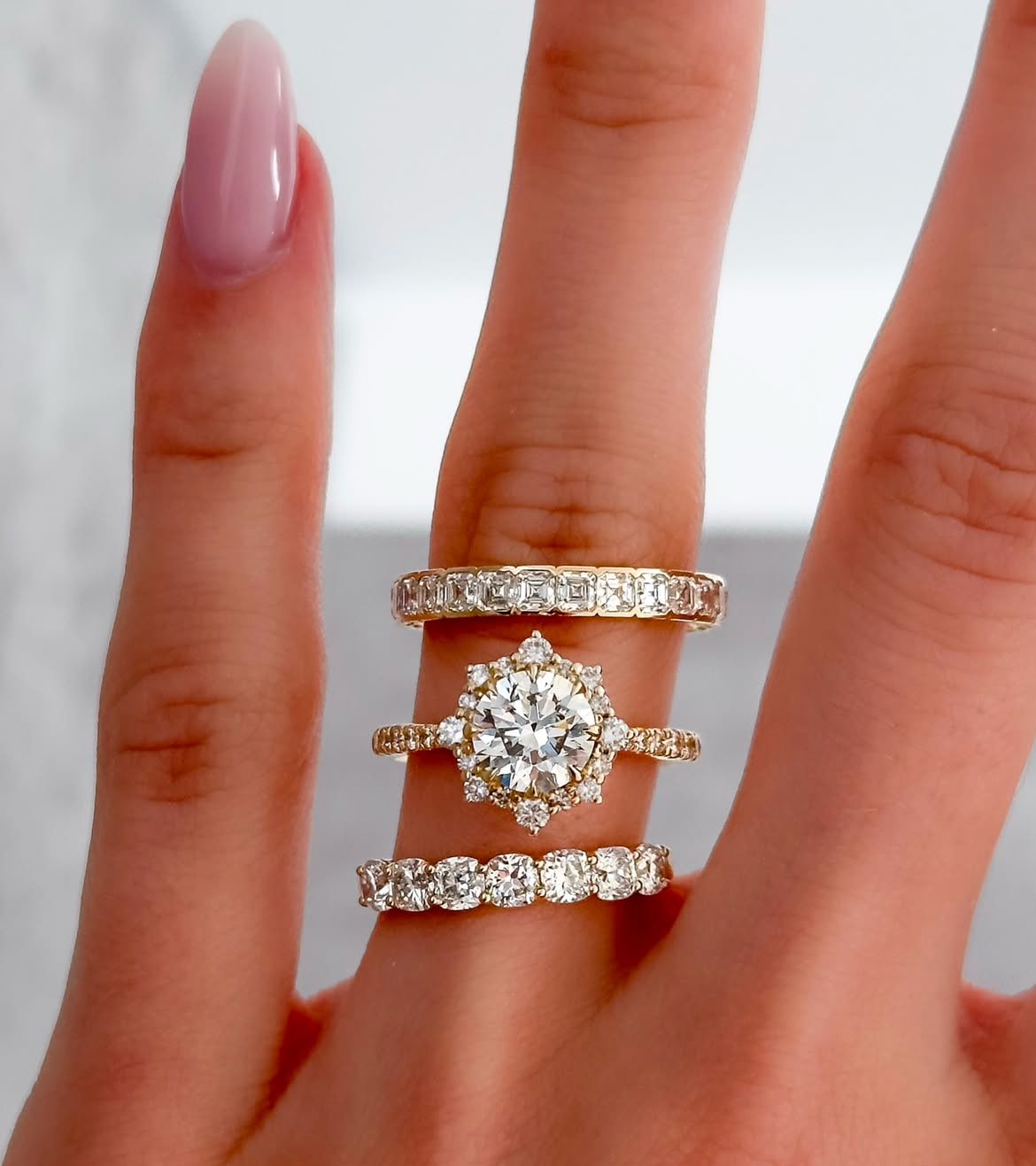halo mounted round brilliant yellow gold engagement ring with cushion cut or Asscher cut diamond eternity bands